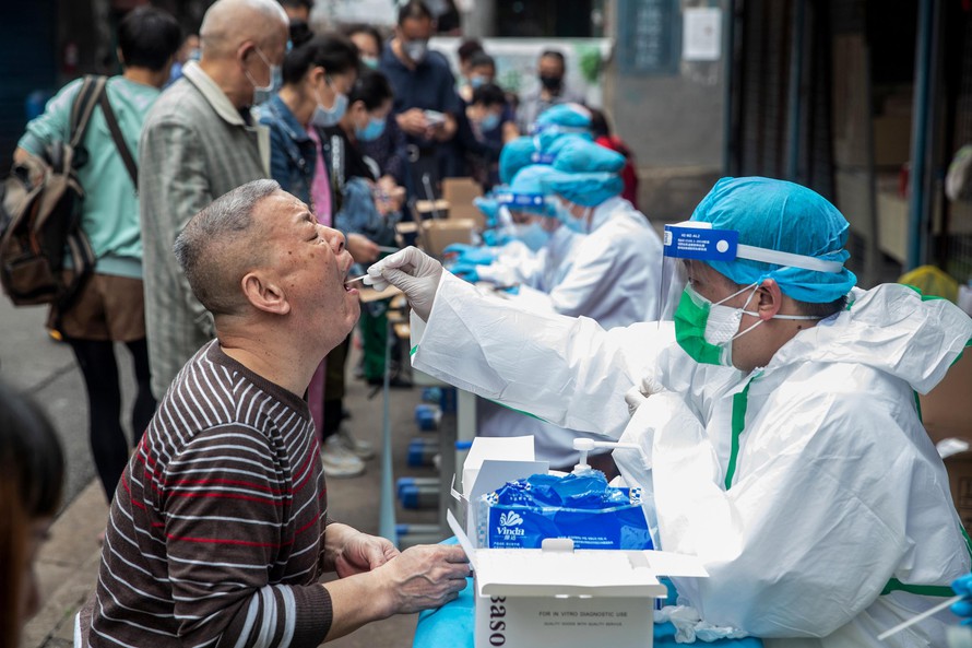 Nhân viên y tế lấy mẫu xét nghiệm COVID-19 cho người dân tại Vũ Hán. Ảnh: Xinhua